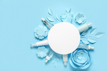 Facial cosmetic products composition with blank card on blue background