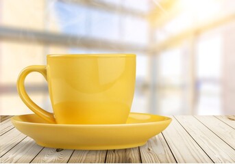 huge ceramic yellow mug on the desk