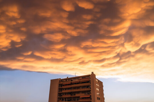 Residential ower building under dramatic sunset cloud. High quality photo