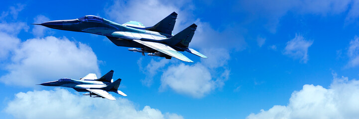 Pair of Fighter Jets Soaring Side by Side in a Clear Blue Sky