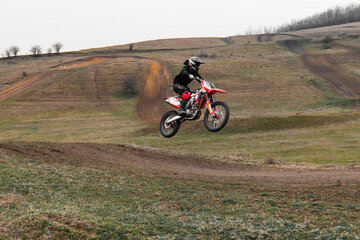 Riding a motorcycle with helmet on an offroad track