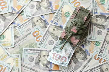 Tank on crumpled hundred dollar bills banknotes. Background of war funding and military support price for United States of America