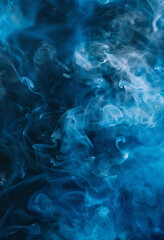 Abstract blue smoke against a dark black background, with a misty blue hue settling on the ground.