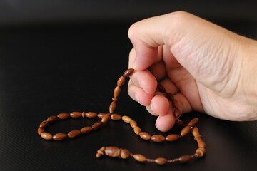 hand of muslim praying with rosary. ramadan and praying.