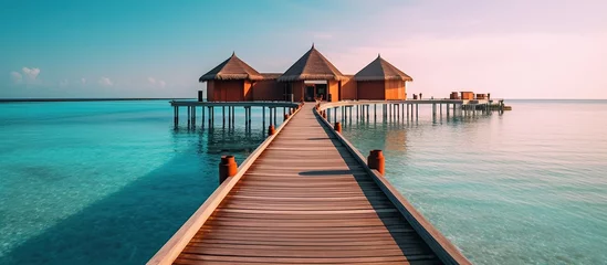 Fotobehang Wooden pier in the sea at Maldives © Daisha