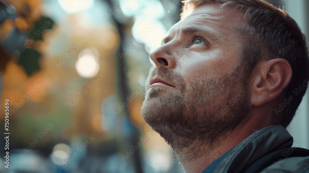 Poster close up shot of a man looking up. great for illustrating curiosity and contemplation