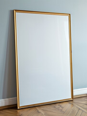 Elegant Golden Framed Blank Canvas Leaning Against Blue Wall
