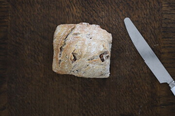 bread and knife on wooden surface