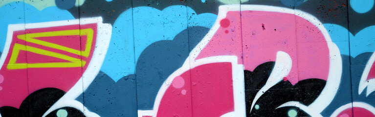 Colorful background of graffiti painting artwork with bright aerosol outlines on wall. Old school...