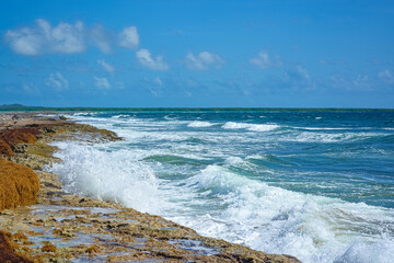 Waves splashing at the rough shoreline of the tropical island of Bonaire.