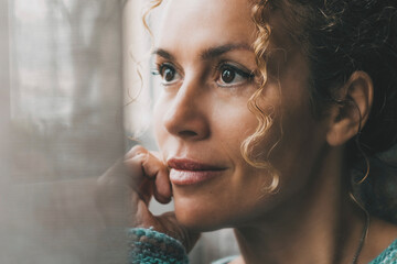 One confident lady contemplate outside the window at home with dreaming and thoughtful expression...