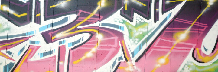 Colorful background of graffiti painting artwork with bright aerosol outlines on wall. Old school...