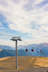 cable car cabins at a height against the backdrop of beautiful mountains - 750975219