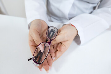 Woman holding eyeglasses, a stylish fashion accessory for vision care