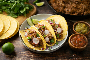 carnitas tacos with salsa and lime
