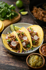carnitas tacos with salsa and lime
