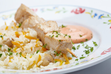 rice with chicken kebab and sauce
