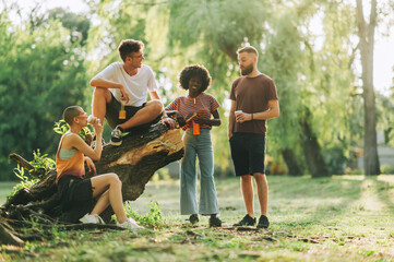 Portrait of multicultural friends spending time together in nature.