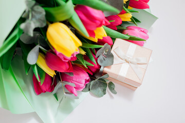 Women's day background. Spring flowers. Bouquet of yellow and pink tulips. Present gift for Mother's day. Space Top view