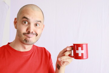 funny bald man holding a switzerland flag printed mug ,swiss coffee and chocolate beverage advertising template 