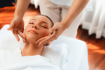 Caucasian woman enjoying relaxing anti-stress head massage and pampering facial beauty skin...