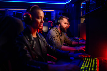 Portrait of a bearded man cybersport gamer playing a video game with his team