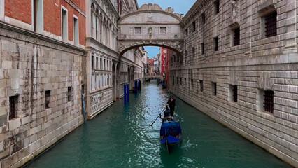 Fototapeta na wymiar Medieval houses, narrow canals, bridges and gondolas in Venice, Italy, February 10, 2024.