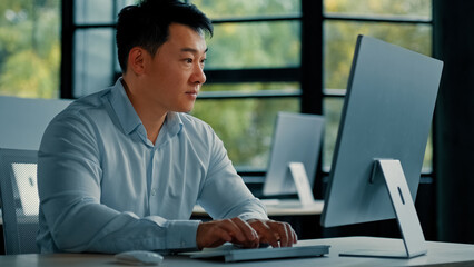 Concentrated mature asian japanese korean man office worker professional businessman entrepreneur...