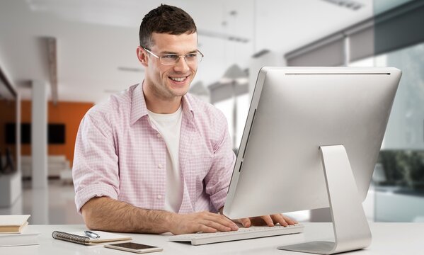 Middle aged professional businessman sitting at desk in office