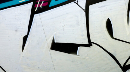 Colorful background of graffiti painting artwork with bright aerosol outlines on wall. Old school...