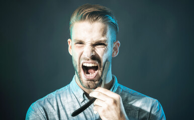 Barber shop equipment. Closeup portrait of screaming unshaven man in denim shirt with vintage straight razor. Handsome male with beard and mustache dangerous razor for shaving. Barbershop advertising.