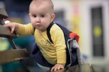a one-year-old child, a boy, a joyful baby walks