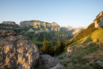 Fototapeta na wymiar Beautiful early morning summer view with warm light on Marwees mountain and summit, seen from Aescher Mountain cabin in the Swiss Appenzell Alpen. Morning in the beautiful Swiss Alps. Mountain view.