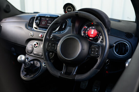 Compact sports car interior with a focus on the steering wheel