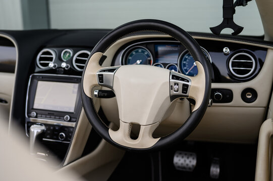 Modern Luxury Car Interior, Leather Steering wheel, Cream and Black Trim
