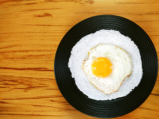 Typical Brazilian snack know as tapioca	with fried egg on the wooden background
