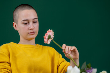 short hair girl smelling a flower 
