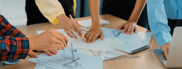 Skilled architect engineer team discuss about architectural project while project manager using...