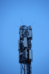 A tall tower with many antennas on top - 751004870