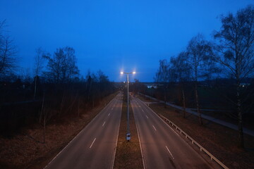 A road with two lanes and a street light in the middle - 751005239