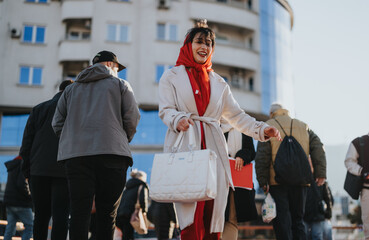 A cheerful woman in a red scarf and white coat joyfully walks with coworkers through a bustling city street, embodying urban lifestyle and professional camaraderie.