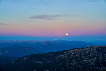 The moon in twilight in the Austrian Alps