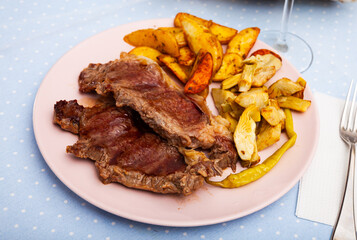 Healthy dinner, veal steak baked in oven with potato, artichokes and pickled pepper