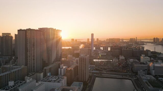 sun rising over tokyo city bay aerial view drone business residential ward,modern buildings skyscrapers skyline at sunrise