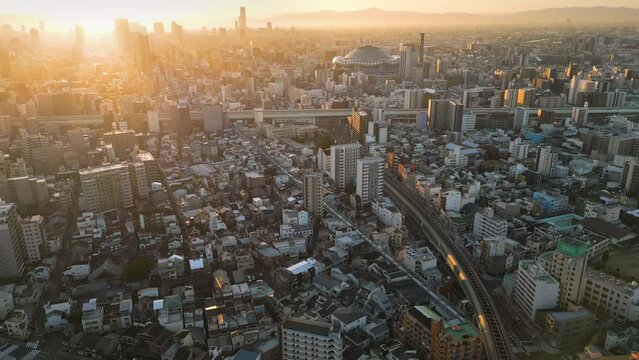 osaka city skyline aerial view drone sun rising over business residential nishi ward at sunrise