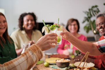 Focus on toasts at a friends dinner at home. Concept: lifestyle, together, fun, friendship