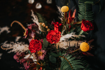 Red and yellow rustic wedding table floral arrangement  