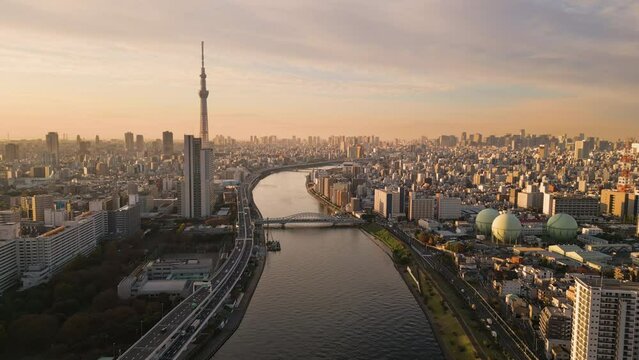 aerial view drone tokyo city skyline at dawn skytree tower asakusa district,flying over sumida river with downtown in the background at sunrise