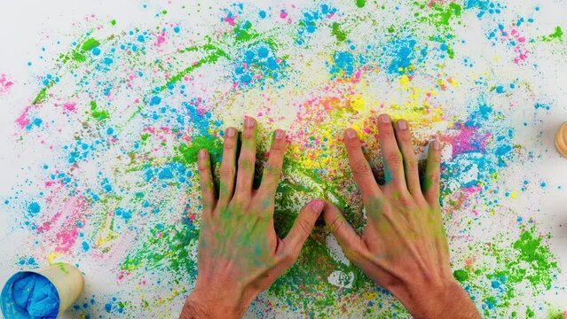 Hands Of Man Touching Holi Colored Powder On White