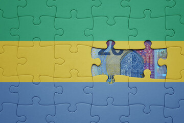 puzzle with the national flag of gabon and euro banknote. finance concept